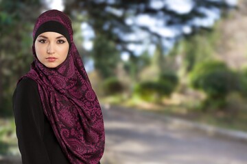 young happy muslim woman posing outdoors.
