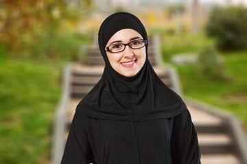 young happy muslim woman posing outdoors.