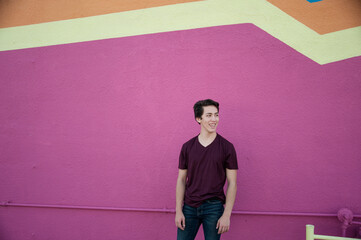 Photos of an acrobatic young man near an urban mural. 