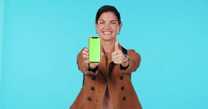 Green screen phone, thumbs up or happy woman point at mockup travel app, brand satisfaction feedback or media space. Approval portrait, cellphone logo or studio person voting on ad on blue background
