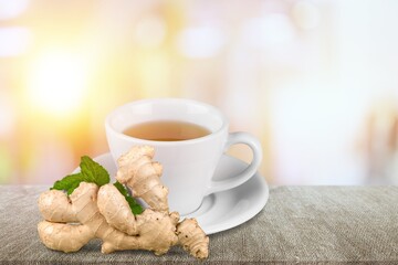 A cup of hot tasty ginger tea with root