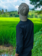 sky, grass, hat, nature, field, person, boy, woman, guy, winter, green, outdoors, child, outdoor, outside, standing, face, smile, men, casual, blue, youth, fashion, landscape