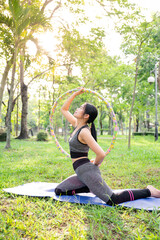 Exercising with Hula Hoop in the park