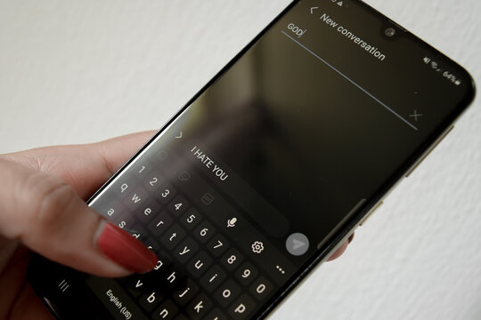 A woman hand holding a cell phone and sending a short message to God, montreux 30 june 2023, switzerland