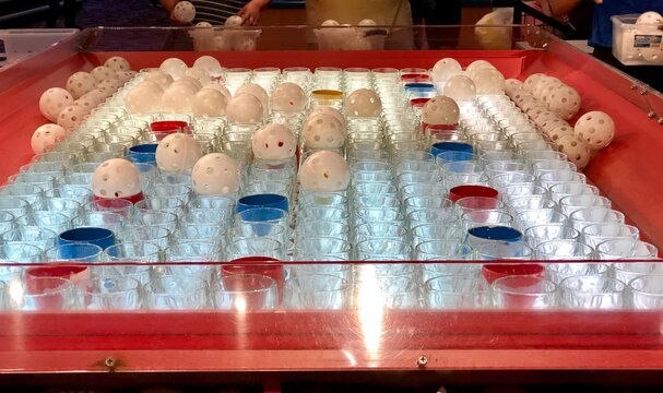 Midway game of chance - land the whiffle ball in a colored glass to win a prize