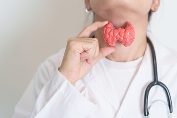 Doctor with human Thyroid anatomy model. Hyperthyroidism, Hypothyroidism, Hashimoto Thyroiditis,...