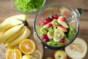Healthy smoothie ingredients in blender bowl, top view. Various fruits , vegetables and berries. Close up mixed fruits