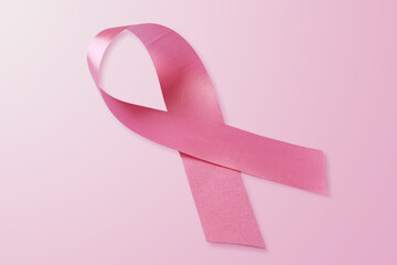 Breast cancer awareness pink ribbon on light pink background
