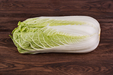 Fresh ripe chinese cabbage on a brown wooden background