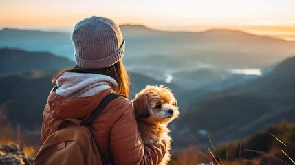 Selbstklebende Fototapete Dämmerung mountain view background and back side of tourist woman. she's traveling with dog. they are best friend. she's holding a dog at view point at mountain. morning light and bokeh. Ai generated. 