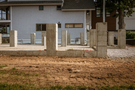 Flood-Resistant Pier, Piles. The placement is for a steel support beam. Gravel compacted base for the floor. These piers raise the houses to withstand storm surges and minimize storm damage in a storm