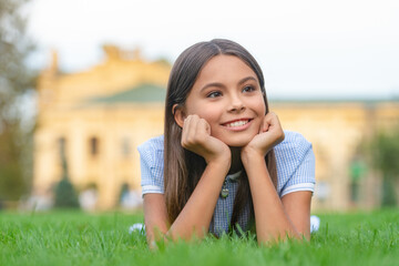 Naklejka na ściany i meble smiling girl relax at summer lawn outdoor. photo of girl relax at summer lawn.