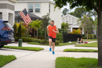 sport fit man jogging outdoor. The running man races down the neighbourhood. Choose an active lifestyle. running man enjoys the freedom of running outdoor. running man feels sense of joy during run