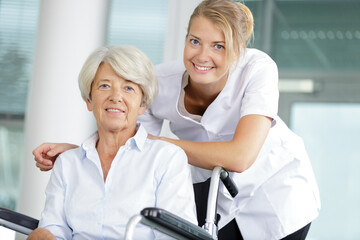 senior woman in wheelchair and a nurse
