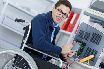 man in wheelchair working with photocopier