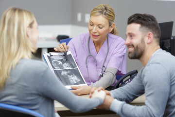 Fototapeta premium doctor or gynecologist or obstetrician physician showing ultrasound photo