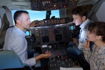 pilot and students in a airplane cockpit © auremar