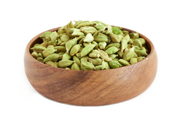 pile of green cardamom cardamon  in wood plate isolated on white background. green cardamom cardamon isolated. heap of green cardamom cardamon isolated                                             