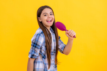 haircare of teen girl sing with hairbrush. teen girl taking care of her hair with a hairbrush,...