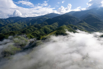 Fototapeta premium Top view Landscape of Morning Mist with Mountain Layer at north of Thailand. mountain ridge and clouds in rural jungle bush forest