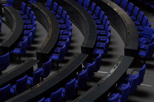 BERLIN, GERMANY - July 1, 2023, empty, blue seats at the Deutscher Bundestag. Reserved for the members of the parliament. The chairs have a special color: Reichstagsblau or Reichstags-Blue.