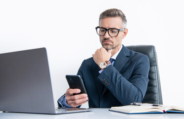 busy businessperson in eyewear using phone in office with computer