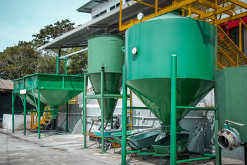 Big separators in green color for separating coffee seeds from outer skin. Coffee processing plant...