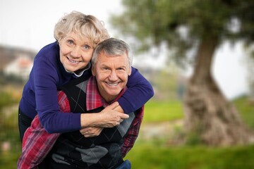 Active senior old couple at park.
