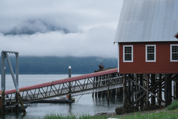 Old cannery in Hoonah, Icy Strait Point Alaska for canning fresh Fish and now serving as cruise travel destination wildlife adventure for tours, kayaking, whale and bird bear watching nature scenery