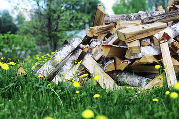 Chopped firewood lies in the woodpile. Wooden background.