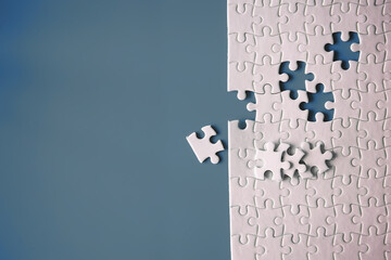 Clean puzzle elements on the red background. Empty puzzle piece on the table. Teamwork concept.