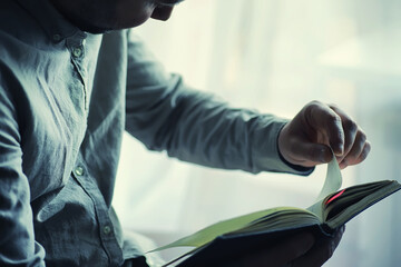 Read book. A man sits and reads religion literature. Textbooks to study.