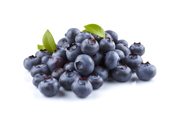 Bunch of ripe blueberries with green leaves on a white background close-up.