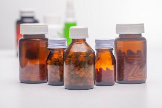 Multiple Unlabeled Pill Bottles Placed On A White Background