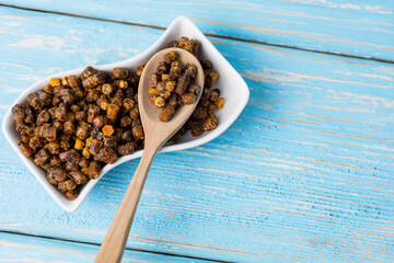 bee parchment in a wooden spoon, close-up. Vitamins, benefits.