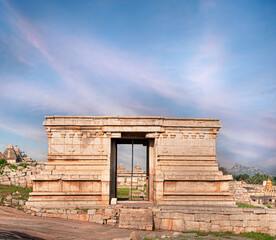 Ancient Hampi temple ruins of antique stone temple tower with blue sky, ancient Hampi Bazaar, Hampi, Karnataka, India