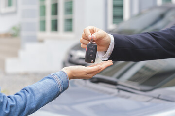 Business car rental, sell or buy service, dealership hand of agent dealer, sale man giving auto key of vehicle to customer renter, buyer young woman receiving, client or tenant, transfer automobile. - obrazy, fototapety, plakaty