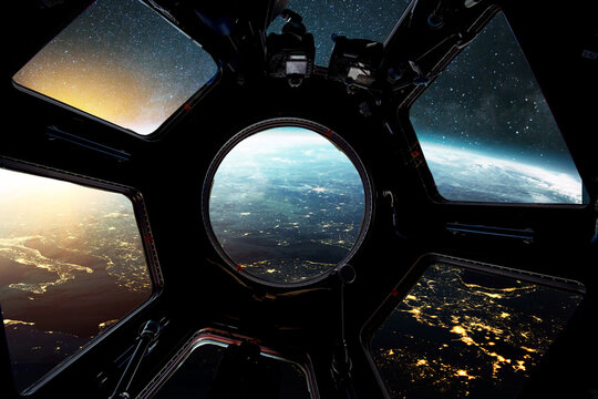 Amazing view from the ISS to the planet earth with city lights at night. New space shuttle fly over the blue planet earth at sunset. Creative idea, space travel and hotel