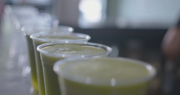 Close Up Head On of a Row of Green Juices