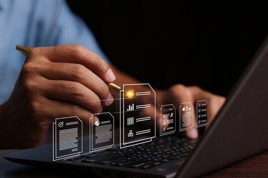 Document Management System (DMS) Being Setup By IT Consultant Working On Laptop Computer In Office With Document Directory. Software For Archiving, Searching And Managing Corporate File Information