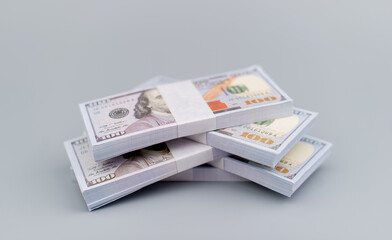 Dollars stacked on gray background. Savings. Investment. Financial planning. Income. Wages. Dividends. Money and time investment strategy.