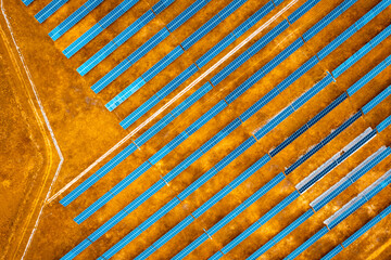 Aerial view over Solar cells energy farm in countryside landscape. Solar panels in aerial view,...