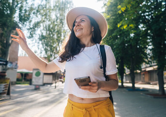 Traveler girl is looking for a way in an unfamiliar city using phone and maps. Tourism, visiting...