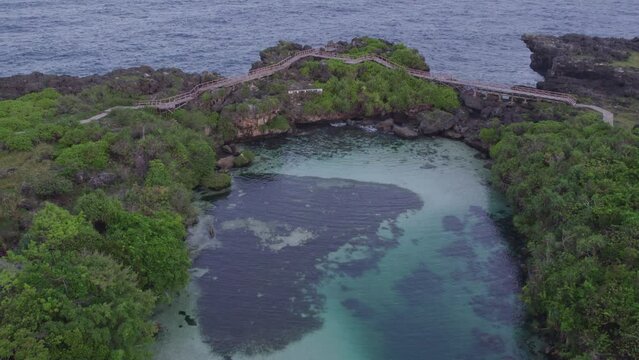 Wide shot of the famous weekuri lagoon at Sumba Indonesia during sunrise, aerial