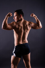 Fototapeta na wymiar Muscular and torso of young man having abs, bicep and chest. Male hunk with athletic body.
