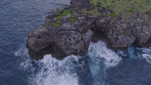 Rocky coastline with small waves at Sumba island Indonesia during sunrise, aerial