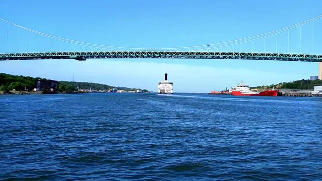 A ferry passes under the Alvsborgsbron bridge in Gothenburg, Sweden. Locked shot
