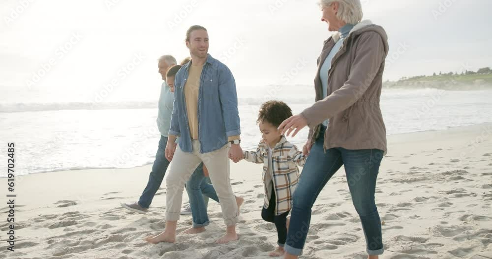 Sticker Happy, holding hands and interracial family on the beach for walking, bonding and holiday. Smile, talking and parents, grandparents and children with affection at the sea for a walk, travel and relax