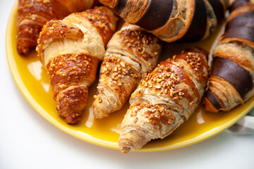 Chocolate croissants or croissant with nut crumbs on a plate. Delicious breakfast on the table....