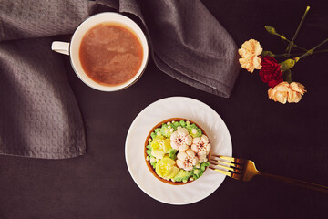 Floral hygge aesthetic - french tart, petals coffee among flowers flat lay.